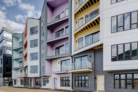 A modern apartment building with balconies and windows.