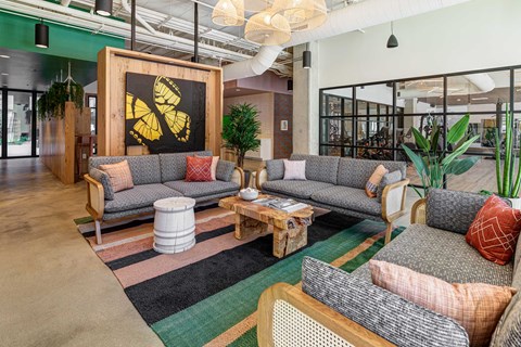 A modern living room with a grey sofa and a wooden coffee table.