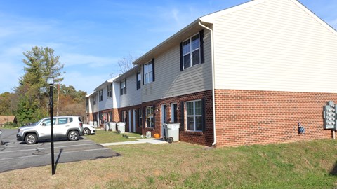 A building with a parking lot in front of it.
