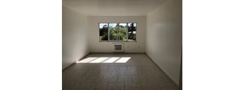 A room with a large window and tiled floor.