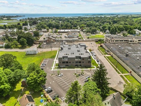 A large building with a parking lot in front of it.