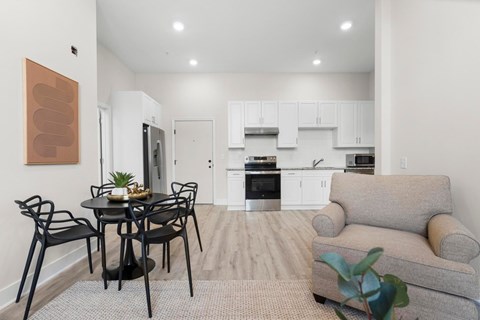 A modern dining room with a table set for four.