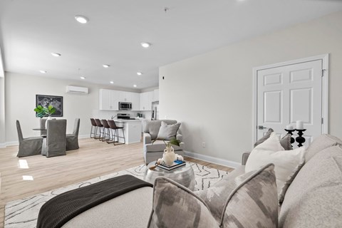 A living room with a grey couch and a coffee table.