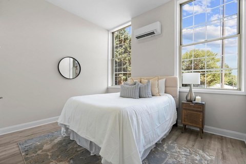 A bedroom with a large bed and a window.