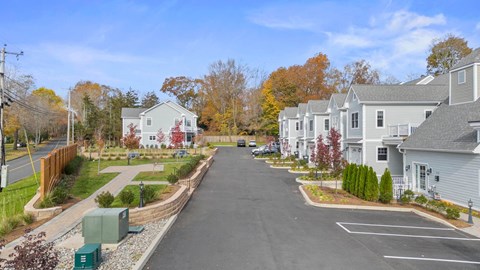 A street view of a residential area with houses on both sides.