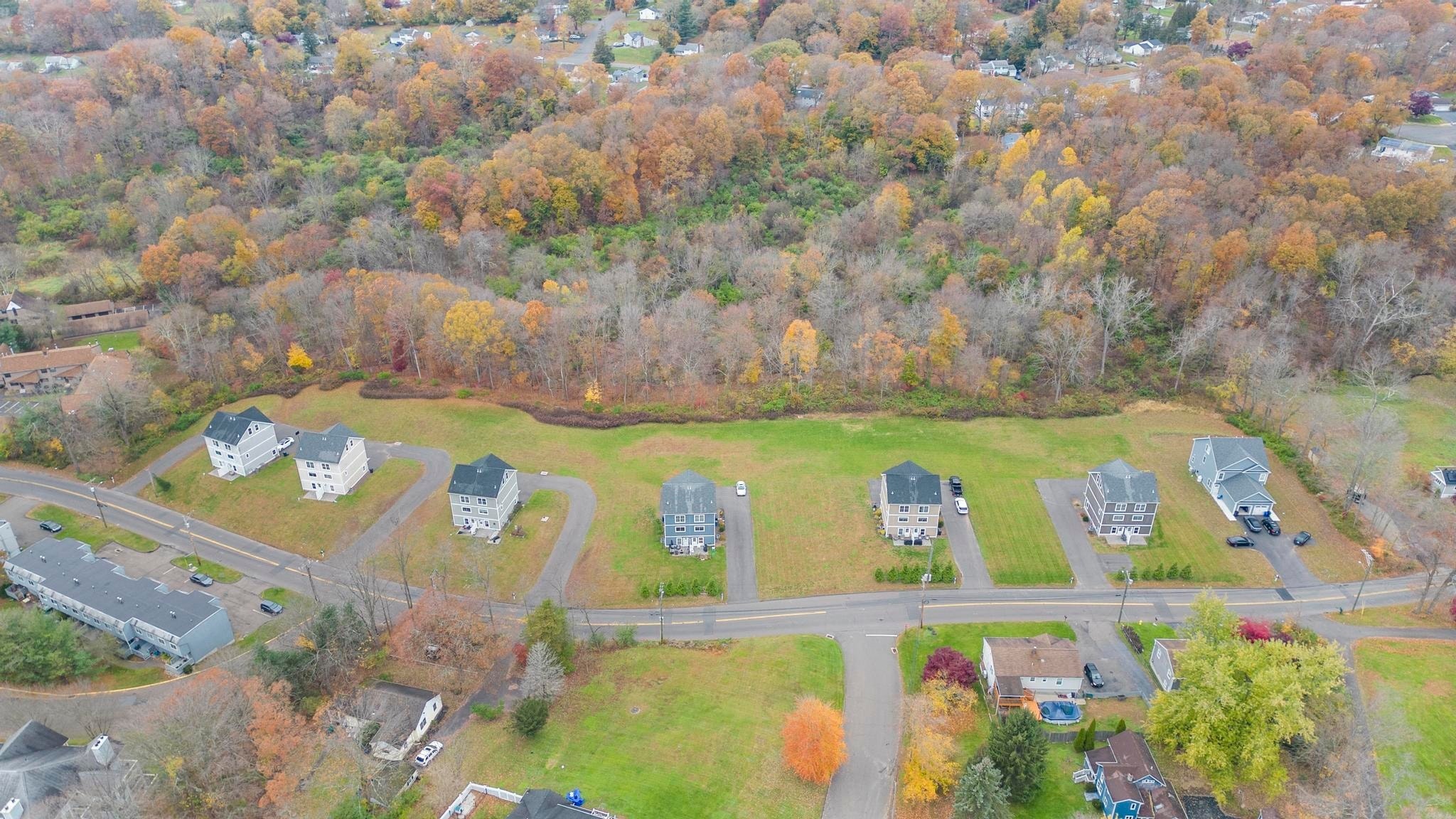 A suburban neighborhood with houses and trees in autumn colors.