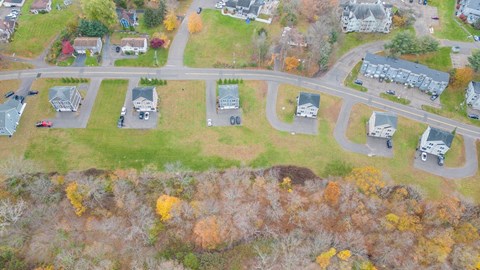A residential area with houses and trees in autumn colors.