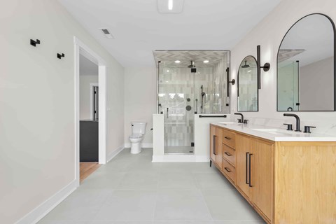 A bathroom with a white toilet and a walk-in shower.