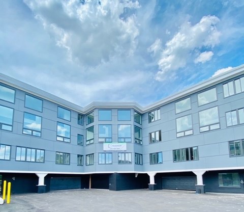 A modern building with a sign that reads "ECOMORE".