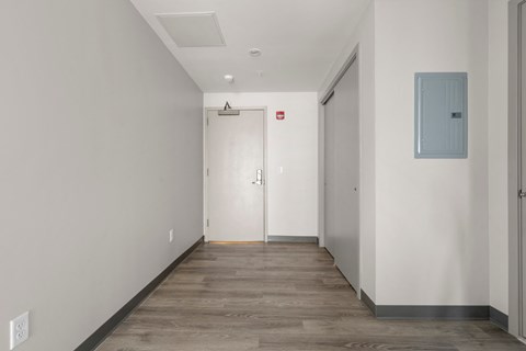 A long hallway with a door at the end.