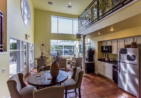 A kitchen with a table and chairs in the middle of the room.