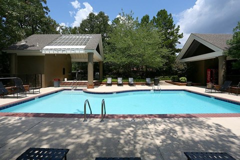 A pool with a metal grate in the middle of it.