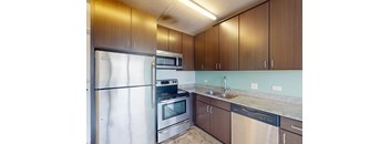 A kitchen with brown cabinets and stainless steel appliances.