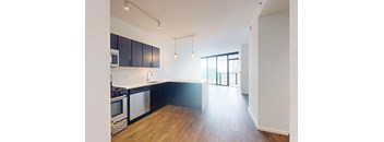 A kitchen with black cabinets and a white backsplash.
