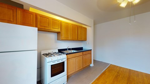 A kitchen with wooden cabinets and a white refrigerator.