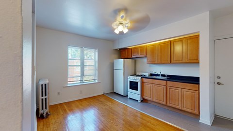 A kitchen with wooden cabinets and a white refrigerator.