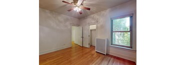 A room with a ceiling fan and a window.