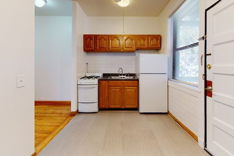 A kitchen with a white dishwasher and a white refrigerator.