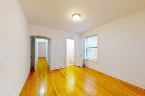 A room with wooden floors and white walls.
