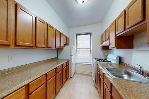 A kitchen with wooden cabinets and a granite countertop.
