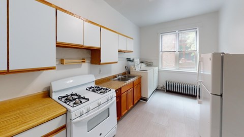 A white stove and oven in a kitchen with wooden cabinets.