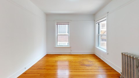 A room with wooden floors and white walls.