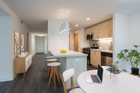 A modern kitchen with a dining table and chairs.