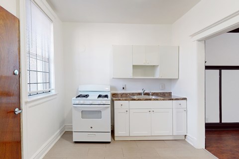 A kitchen with a stove and sink.