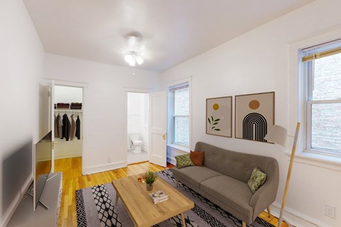 A living room with a grey couch and a wooden coffee table.
