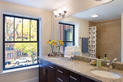 A bathroom with a large window and a sink.