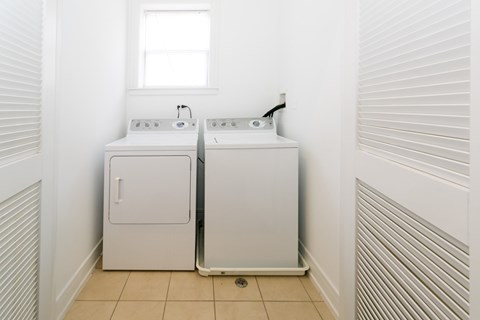 A bathroom with two sinks and a window.