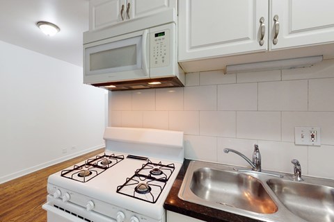 A white stove and sink in a kitchen.
