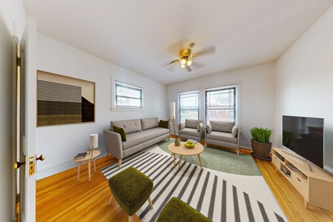 A living room with a striped rug and a grey couch.