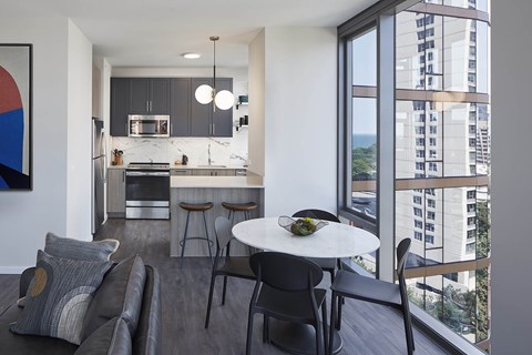 A modern kitchen with a dining table and chairs.