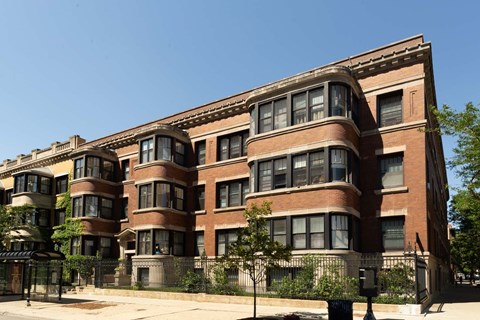 A large red brick building with many windows and balconies.