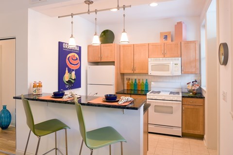 A kitchen with a dining table and two chairs.