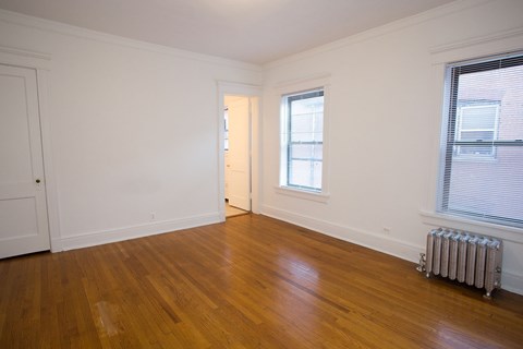 A room with wooden floors and a window.