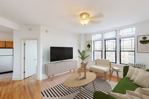 A living room with a television, a sofa, and a coffee table.