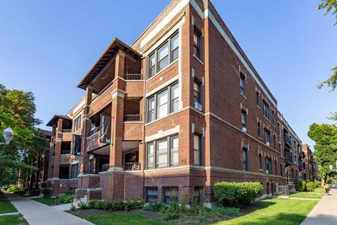 A red brick building with a balcony on the second floor.