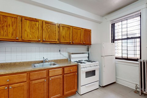 A kitchen with wooden cabinets and white appliances.