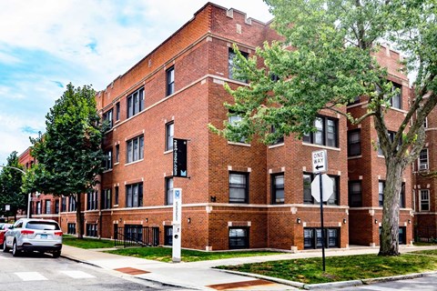 A red brick building with a white sign on the front.