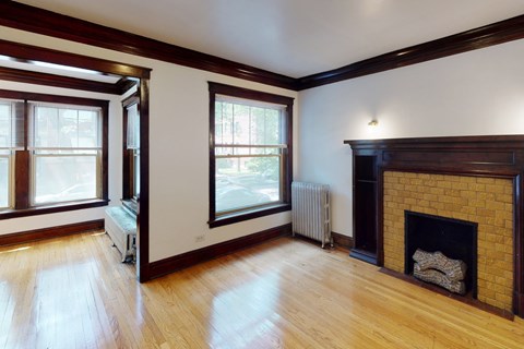 A room with a fireplace and a window.