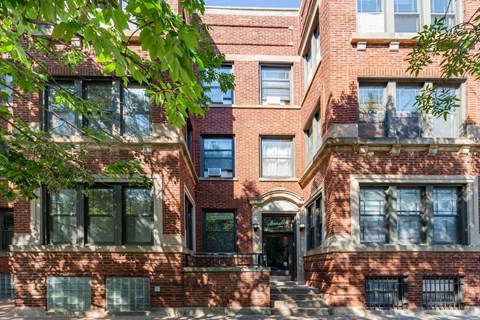 A red brick building with a black door and windows.