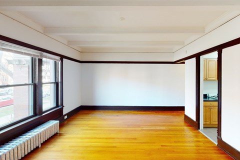 A room with wooden floors and white walls.