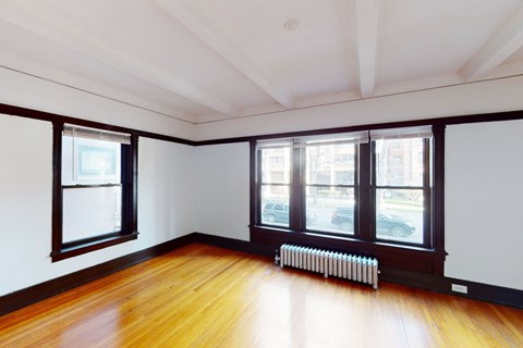 A room with wooden floors and white walls.