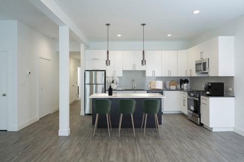 A modern kitchen with a dining table and chairs.