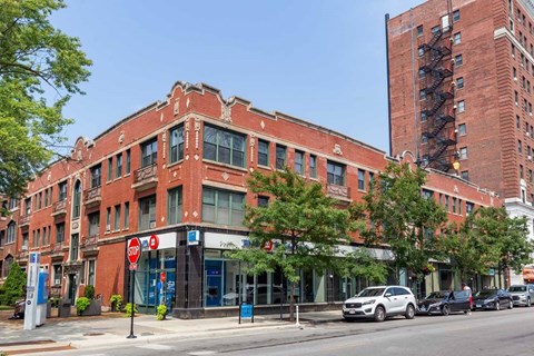 A red brick building with a blue sign on the front.