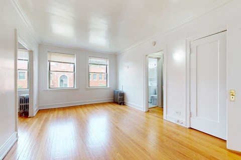 A room with wooden floors and white walls.