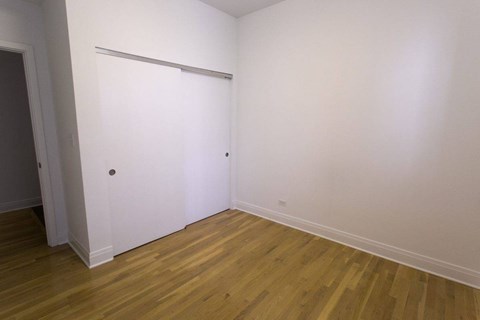 A room with wooden floors and white walls.