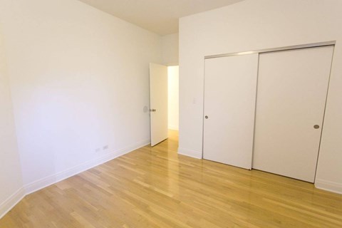 A room with two doors and a wooden floor.